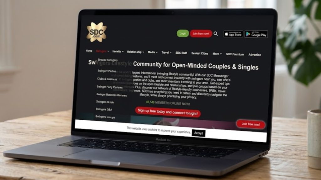 Laptop on wooden table displaying the SDC.com , one of the best swinger apps , website homepage.