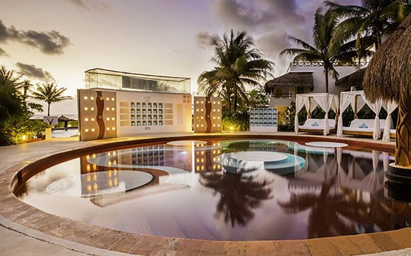 Desire Pearl Jacuzzi Lounge lit at dusk, a couples-only space at the adults-only Mexico resort