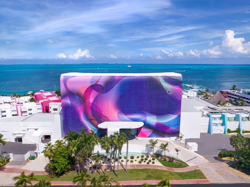 Temptation Cancun Resort tower with its signature mural facade above the Caribbean in the Cancun Hotel Zone