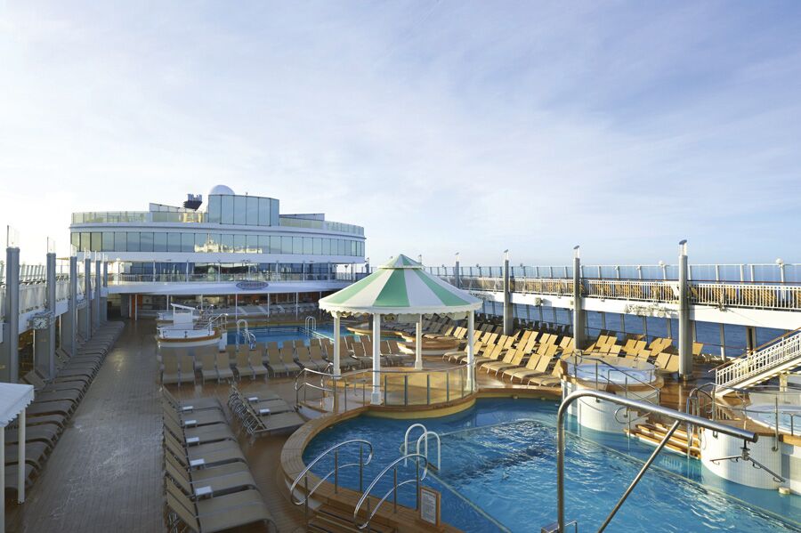 Norwegian Jewel pool deck with hot tubs and loungers, the clothing-optional zone on the Temptation Caribbean Cruise